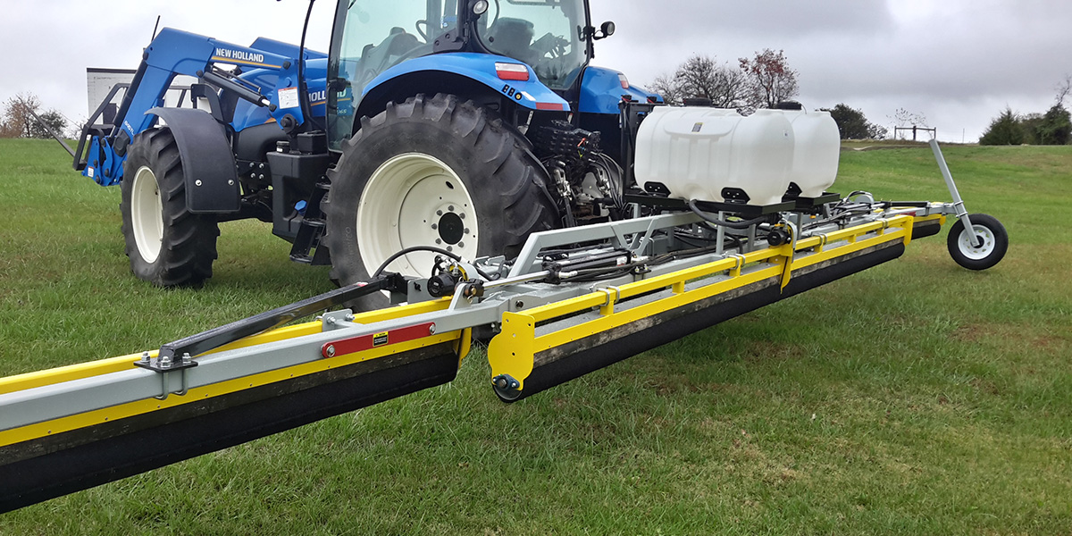 A GrassWorks Flex Unit Weed Wiper in action, applying herbicide precisely to control weeds in pastures while protecting desirable forage grasses.
