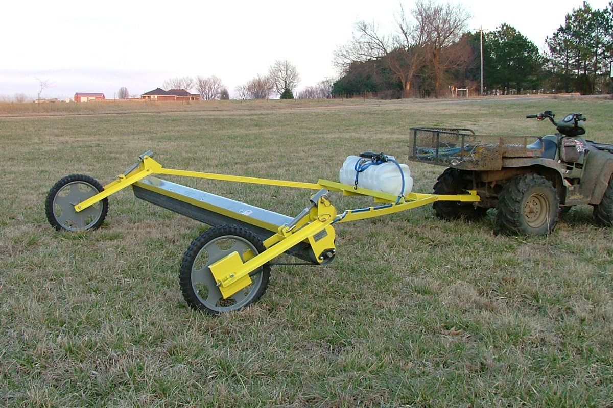 A GrassWorks Pull-Type Weed Wiper mounted to an ATV, designed for efficient and precise herbicide application in pastures and hayfields.