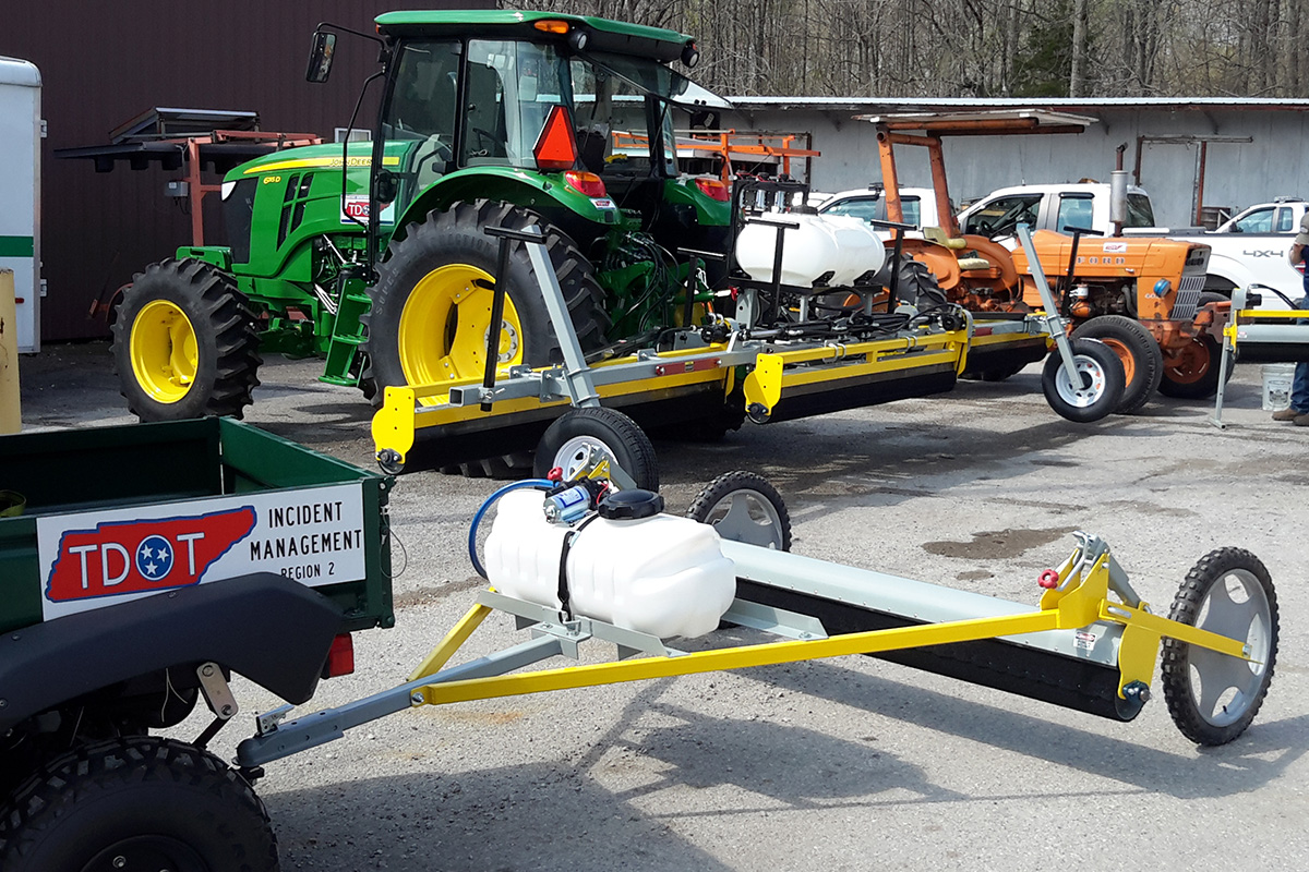 TDOT (Tennessee Department of Transportation) using GrassWorks Weed Wiper for roadside vegetation management with a John Deere tractor.