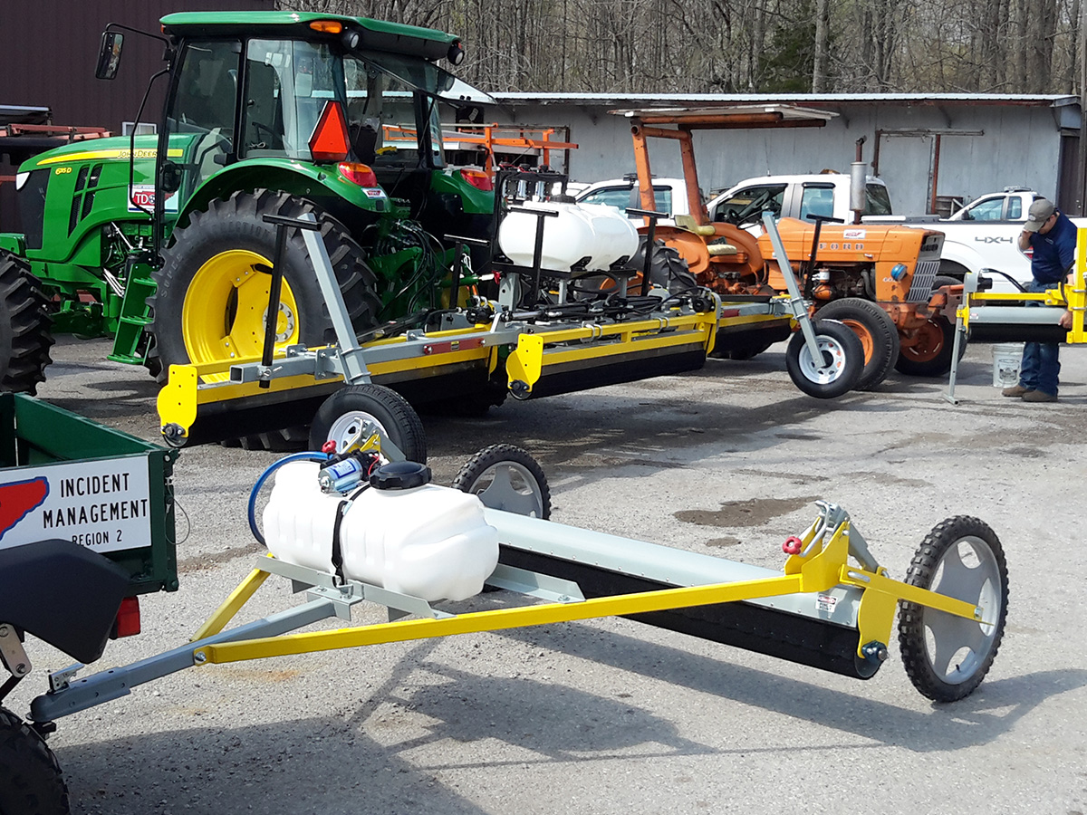 A Tennessee Department of Transportation (TDOT) roadside maintenance setup featuring GrassWorks Weed Wipers for controlling Johnson grass along highways.